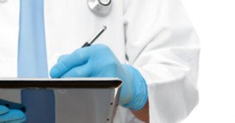 Healthcare Doctor Writing on Tablet