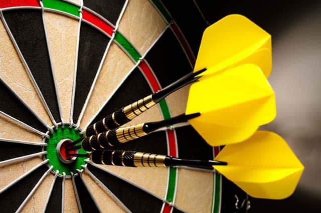 yellow darts in the bullseye of a target