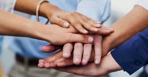 Group of clasping hands