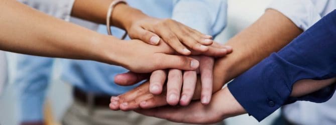 Group of clasping hands