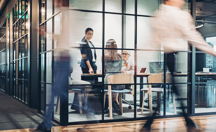 Business persons walking and working around the office building