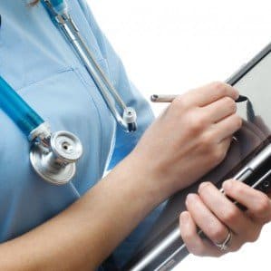 Healthcare Nurse Writing on Tablet e1403108695906